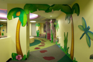 Custom color printed carpet with a jungle theme at an indoor children's hospital.